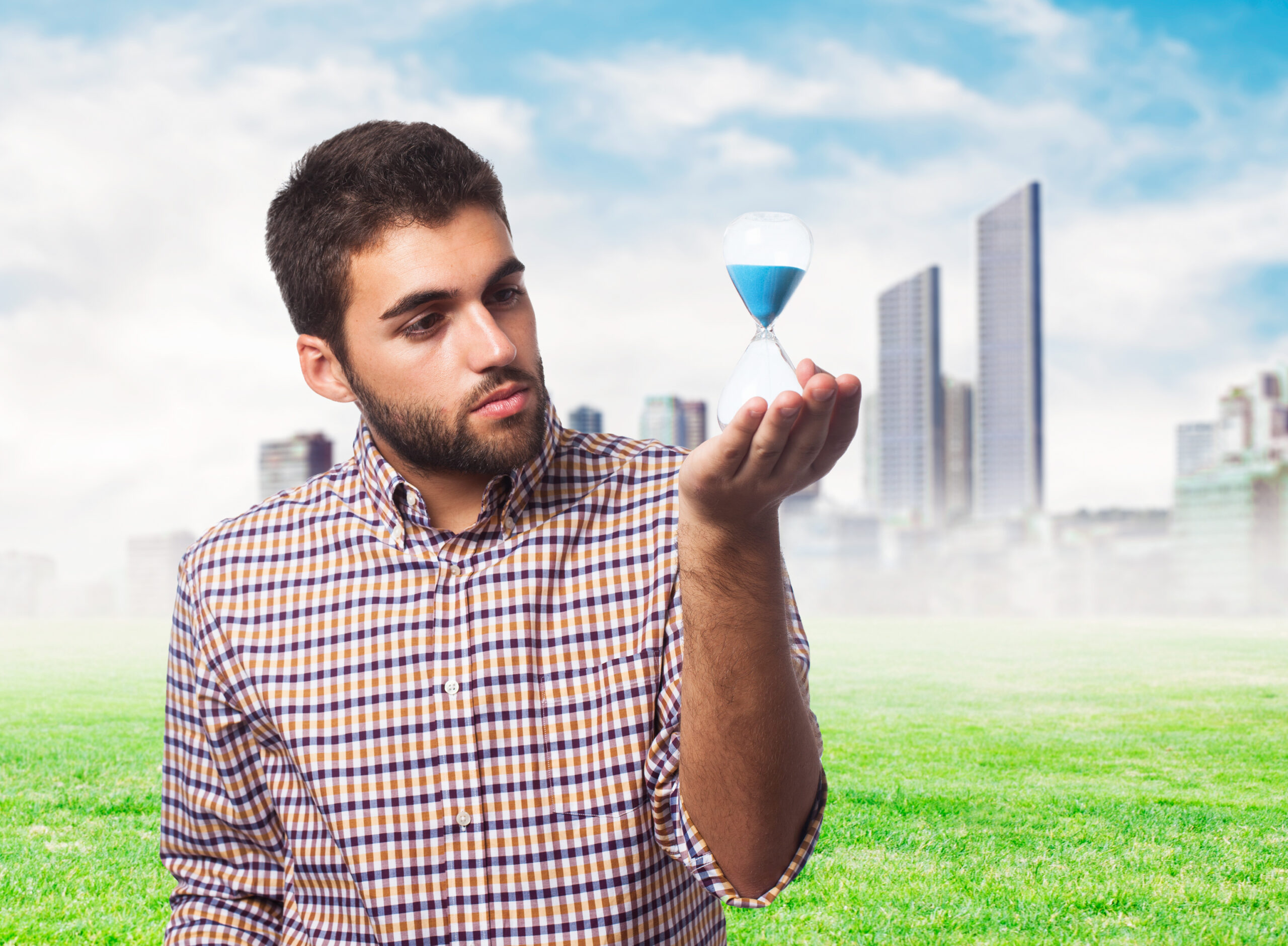 portrait of a young man holding a sand timer